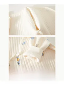 Detail of boneless stitching on cream cotton baby bodysuit for newborn skin comfort