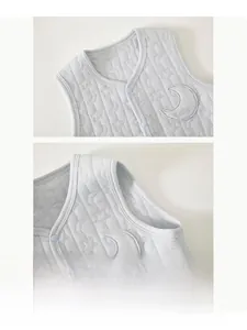 Close-up of quilted baby vest featuring star patterns and embroidered moon detail