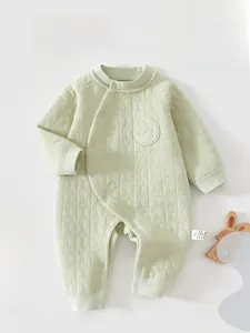 Close-up of light green quilted baby romper featuring star patterns and Baby embroidery