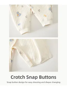 Detail view of crotch snap buttons on cotton baby romper with blue dinosaur pattern