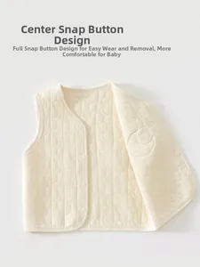 Detail of baby quilted cotton vest featuring moon star patterns and snap button closure