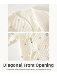 Detail of baby quilted cotton romper with side-tie closure and cute dinosaur print