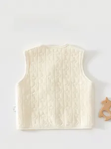 Quilted baby vest detail featuring cute moon and star embroidery on soft cotton fabric