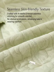 Light green thermal baby romper featuring heart quilted fabric and flat-lock seams