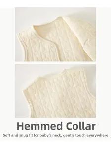 Detail of baby quilted vest featuring moon and star embossed pattern with a bound neckline