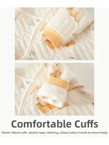 Detail of newborn warm top showing elastic ribbed cuffs and quilted pumpkin bear pattern