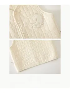 Close-up of quilted star-moon pattern and moon embroidery on baby cotton vest