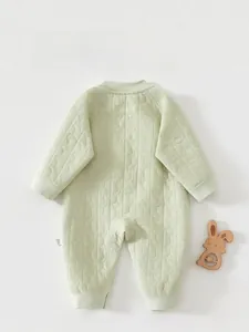 Detailed back view of a light green quilted baby romper with star and moon texture pattern