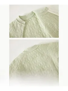Detail of baby quilted romper showing soft star patterns and comfortable piped neckline