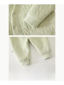 Detail of baby quilted romper showing elastic ribbed cuffs and star-moon embossing