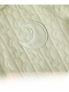 Detailed view of baby thermal romper featuring star moon jacquard and Baby embroidery