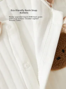 Detail of baby romper with food-grade POM resin snaps and soft bear embroidery