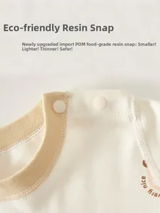 Detail of infant cotton top featuring safe POM resin snap buttons on the shoulder