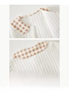 Detailed close-up of the baby romper quilted collar with checkered trim and buttons