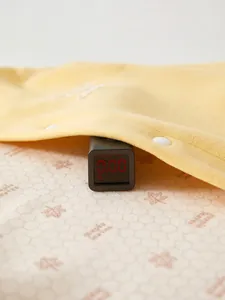 Newborn thermal silk cashmere romper showing zero formaldehyde and fluorescent safety test