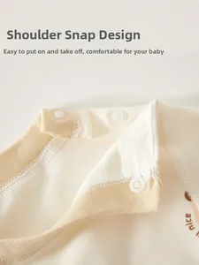 Close-up of baby cotton top shoulder snaps and ribbed neckline with nice print