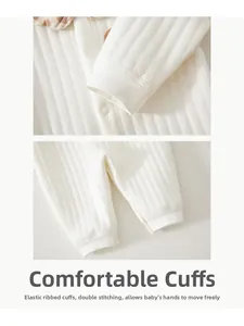 Detail of elastic ribbed cuffs and double-stitched leg openings on baby cotton romper