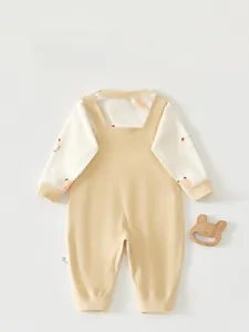 Detailed back view of a baby cotton romper with cute bear prints and suspender design