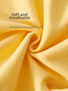 Macro shot of breathable yellow fine-spun cotton fabric texture for newborn clothing