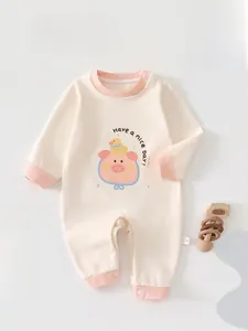 Close-up of baby bodysuit with pink ribbed edges and cute cartoon pig print