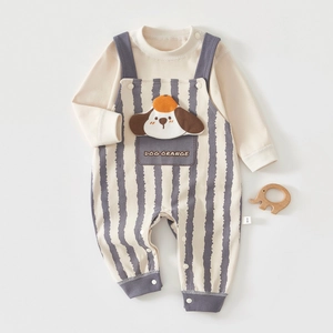 Detail of baby two-piece set with long-sleeved shirt and striped dog pattern overalls