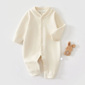 Detail of baby romper snap fasteners and cute bear embroidery on thick cotton fabric