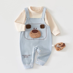 Detailed flat lay of baby autumn set featuring beige top and blue dog overall pants