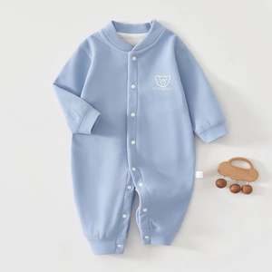 Detail of baby warm light blue cashmere silk romper with snap buttons and bear print