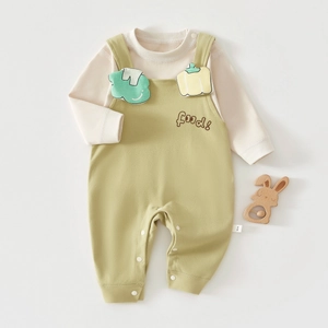 Detail of infant cotton set with snap buttons and cute vegetable embroidery