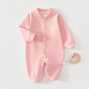 Close-up of pink thermal baby romper featuring cute bear embroidery and snap buttons