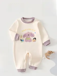 Close-up of baby romper with purple trim and cute cartoon dog print with snap buttons