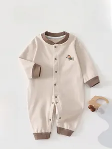 Flat lay of striped baby romper with cute dog patch embroidery and snap buttons