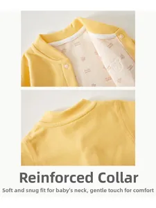 Detail of baby yellow knit onesie featuring edge-binding collar and maple leaf print