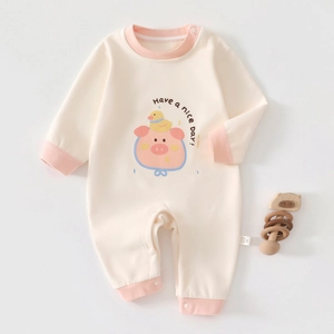 Detail of baby cashmere silk romper with cute pig print and snap buttons for easy wear