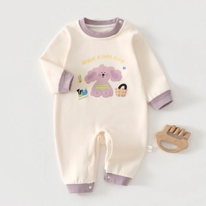 Detail of baby onesie showing soft knit cashmere silk fabric and purple cartoon dog print