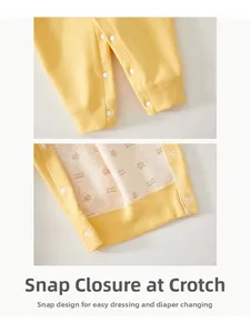 Detailed close-up of newborn bodysuit crotch with durable white resin snap buttons