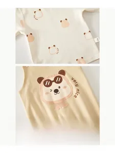 Close-up of baby romper cotton fabric with bear print and soft washing label detail
