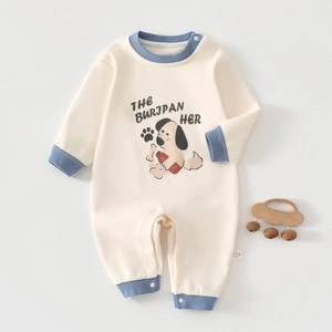 Detail of baby romper with ribbed cuffs, shoulder snaps, and cute cartoon dog print