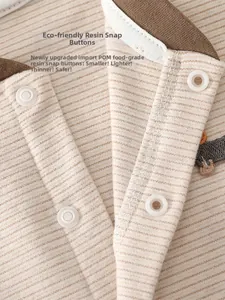 Detail of eco-friendly resin snap buttons on striped baby cashmere silk romper