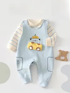 Detail of baby boys striped shirt and blue bear overalls set with button closures