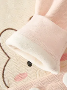 Close-up of baby romper showing pink herringbone knit texture and warm white fleece lining