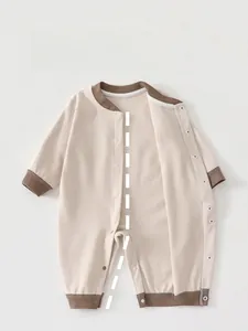 Detail of newborn striped thermal bodysuit showing full snap buttons and soft cotton texture