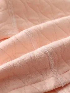 Barboteuse matelassée rose pour bébé avec coutures plates et texture douce en losanges