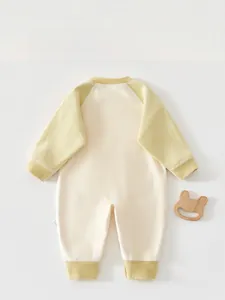 Detail of baby winter jumpsuit with herringbone knit texture and ribbed sleeves