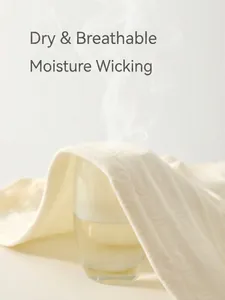 Breathable cream white cotton baby romper showing steam passing through textured fabric