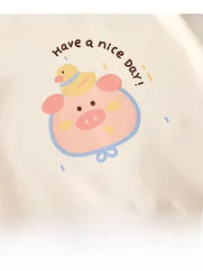 Detail shot of baby romper with cute pig and duck embroidery and Have a nice Day text