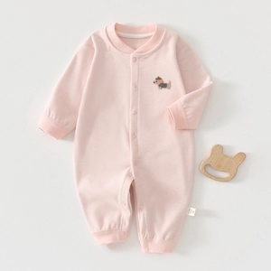 Detail of baby pink knit bodysuit featuring cute puppy embroidery and snap buttons
