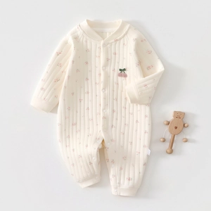 Detail of newborn floral quilted romper with cherry embroidery and ribbed texture