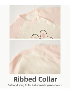 Close-up of the piped neckline and cute bunny motif on this warm baby romper