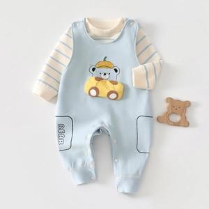 Detail of baby boy overall set with striped long sleeve top and cute bear print